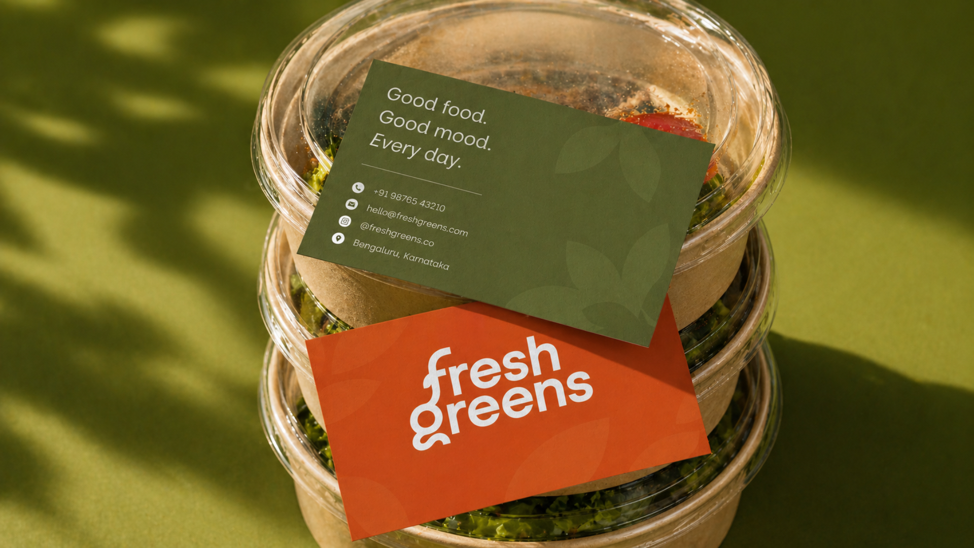 Fresh Greens business cards resting on meal bowls